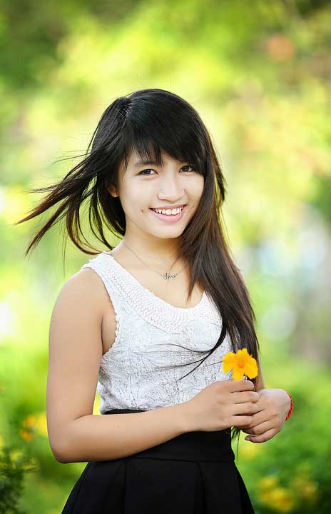 A beautiful girl holding flower in her hand