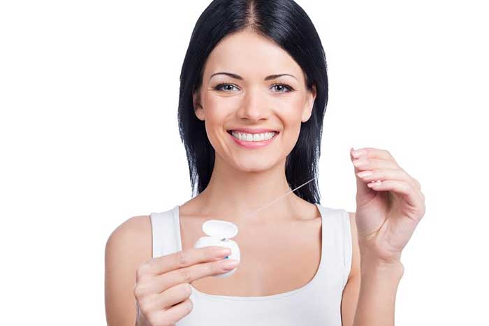 A girl holding floss in her hand